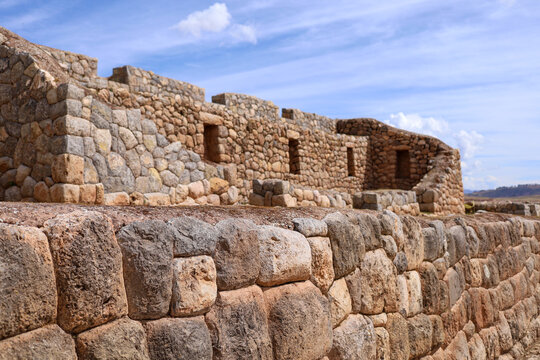 View of the ancient Inca stone walls at the Chinchero archaeological site under a clear blue sky in Cusco, Cusco, Peru.