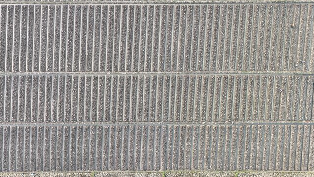 Argapura, West Java, Indonesia - 15 July 2023: Aerial view of Lembah Panyaweuyan featuring intricate terraced fields with rows of crops and soil patterns.