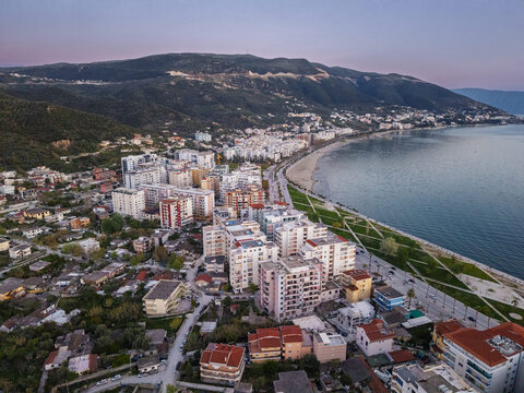 Aerial view of Vlora, featuring modern apartment buildings, a scenic promenade along the Adriatic Sea, and rolling mountains in the background, Vlora, Vlore County, Albania.