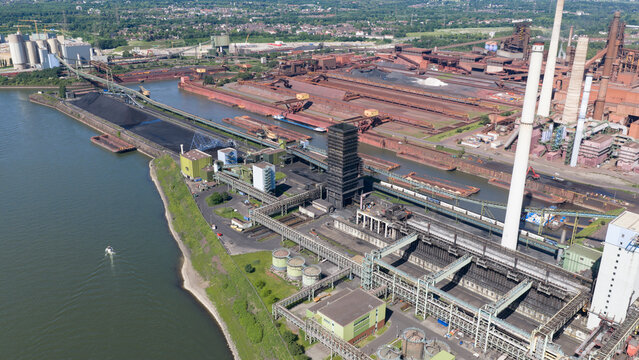 Aerial view of Kokerei Schwelgern coking plant at the thyssenkrupp Steel complex with chimneys and conveyor belts along the Rhine in Duisburg, North Rhine-Westphalia, Germany.
