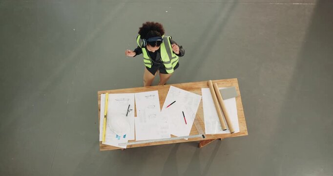 Construction, dance or engineer with headphones, music playlist or playful groove on building site. Space, above or woman with upbeat movement, fun time or radio streaming in development project.