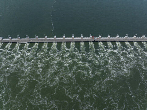 Aerial view of the Eastern Scheldt Storm Surge Barrier with turbulent water flowing through the sluice gates in Vrouwenpolder, Zeeland, Netherlands.