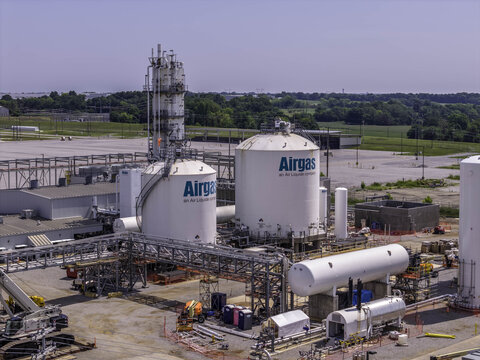 Aerial view of the Airgas industrial gas facility featuring large white storage tanks, complex piping infrastructure, and construction equipment in Clarksville, Tennessee, United States.