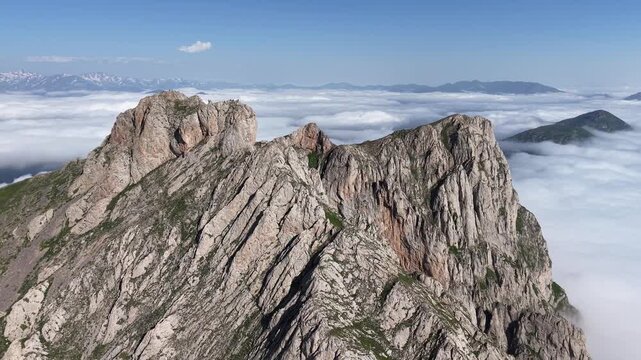 4K UHD Drone Flight Above Dramatic Rocky Mountain Ridge and Sea of Clouds.