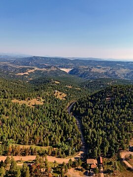 Aerial view of the forested landscape and winding road near Coal Creek, Colorado, United States.