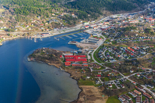 Aerial view of the marina and red-roofed buildings in the coastal town of Henan, Vastra Gotaland, Sweden.