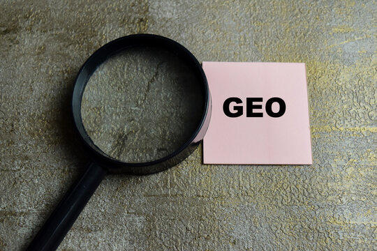 Concept of GEO - Generative Engine Optimization write on sticky notes isolated on Wooden Table.