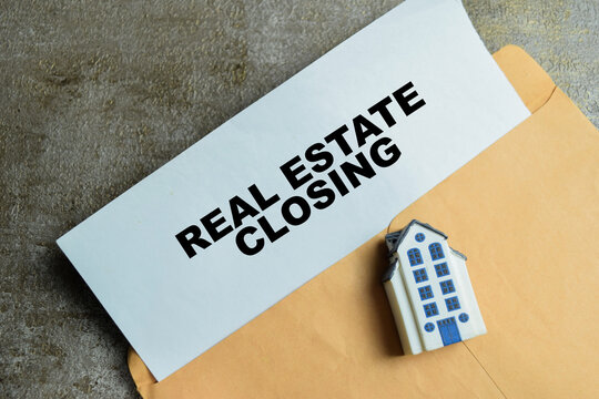 Concept of real estate closing write on legal document isolated on Wooden Table. For property purchase agreement ownership transfer and legal settlement process