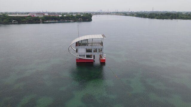 Aerial view of a modern floating structure at Jakabaring Sport City on the lake in Kecamatan Seberang Ulu I, Sumatera Selatan, Indonesia.
