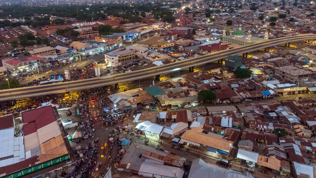 Aerial view of the Tamale Interchange spanning across the urban landscape with a mosque featuring a green dome, busy streets, and dense rooftops in Tamale, Northern Region, Ghana.