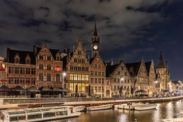 Fototapeta premium Illuminated Historic Guildhalls and Canal View at Night in Ghent, Belgium