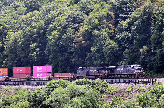 Two Norfolk Southern Railway locomotives lead an eastbound intermodal freight train as it descends the grade around Horseshoe Curve in western Pennsylvania. 