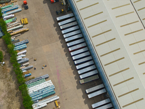 Aerial view of an industrial distribution centre with rows of parked HGVs and freight trailers lined up at loading bays in Doncaster, England, United Kingdom.