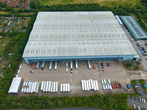 Aerial view of industrial distribution centre with rows of parked HGVs and trailers in a logistics yard in Doncaster, England, United Kingdom.