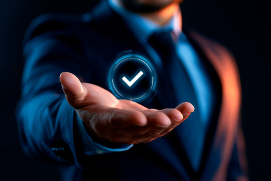 Businessman holding glowing digital check mark hologram over his extended hand for success concept