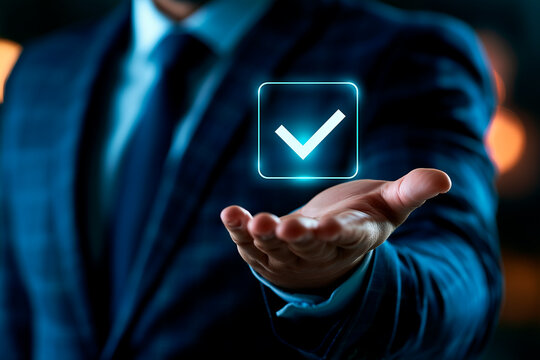 Businessman holding glowing digital check mark hologram over his extended hand for success concept