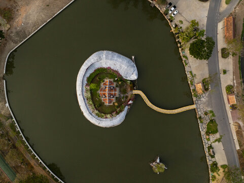 Aerial view of Sumeru Mountain at Ancient City surrounded by a circular moat and lush greenery in Phraeksa, Samut Prakan, Thailand.
