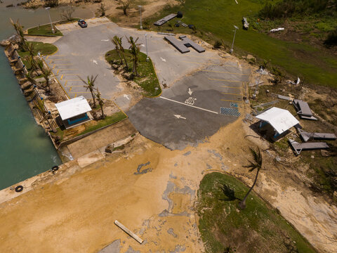 San Jose, Tinian, Northern Mariana Islands - 07 July 2026: Aerial view of Tinian Marina showing storm surge inundation, debris, and damaged infrastructure after super typhoon Bavi.