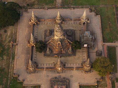 Aerial view of Wat Chaiwatthanaram featuring its central prang, surrounding chedis, and historic brick ruins in the afternoon light in Tambon Ban Pom, Phra Nakhon Si Ayutthaya, Thailand.