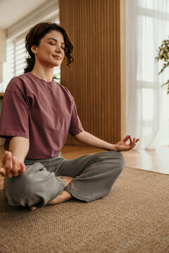 Woman meditating in zen yoga pose for mindfulness