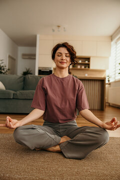 Woman meditating at home finding inner peace and wellness