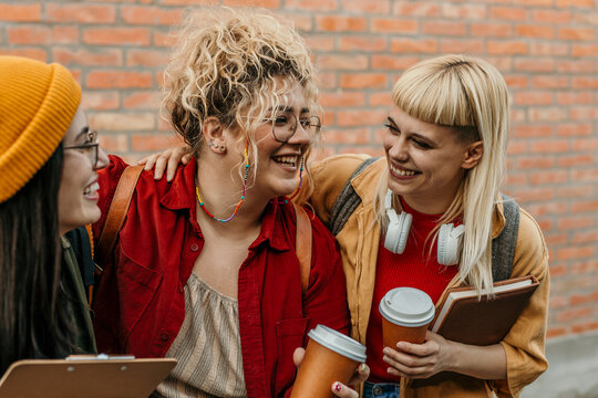 Diverse students laughing together enjoying campus friendship