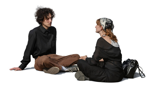Two cool young people sitting outside on the ground and talking, isolated on transparent and white background.