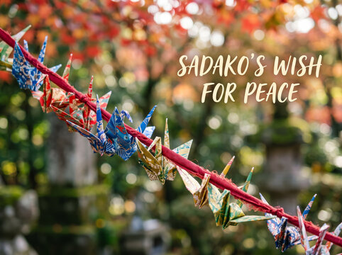 String of Colorful Paper Cranes Hanging in Garden for World Peace Day