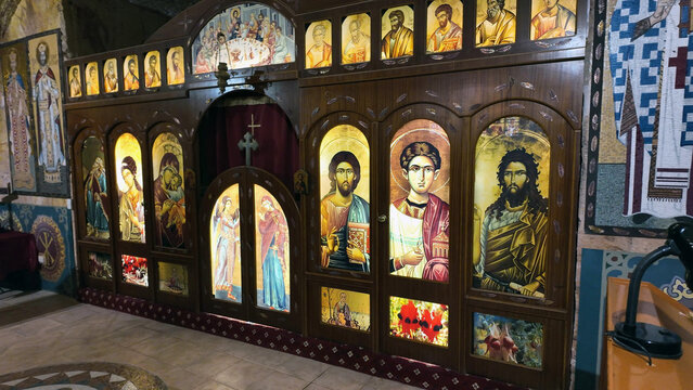 Coober Pedy, South Australia, Australia - 15 January 2025: View of the ornate wooden iconostasis with illuminated religious icons inside the underground Serbian Orthodox Church.