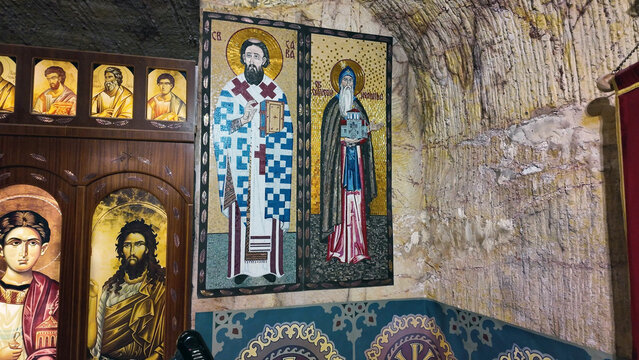 Coober Pedy, South Australia, Australia - 15 January 2025: View of the underground Serbian Orthodox Church interior with religious mosaic icons and carved sandstone walls.
