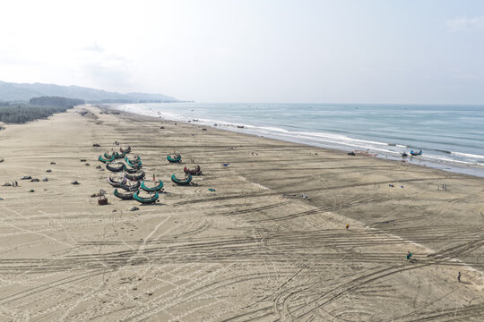 Cox's Bazar, Bangladesh - 10 April 2026: Aerial view of Cox's Bazar Sea Beach with traditional fishing boats resting on the sandy shore along the Bay of Bengal.