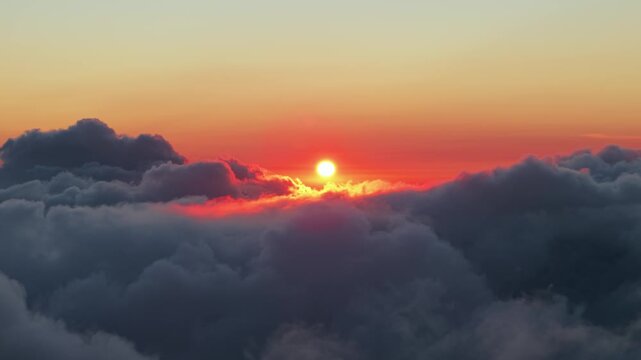 Aerial view of sunrise over the clouds at Dieng Plateau in Kecamatan Batur, Jawa Tengah, Indonesia.