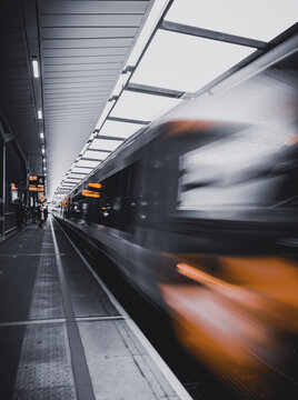 London, England - 07 July 2026: View of a high-speed train passing through a station platform in Central London with blurred motion and modern lighting.