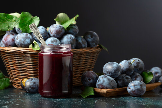 Ripe plums with jam on the kitchen table.