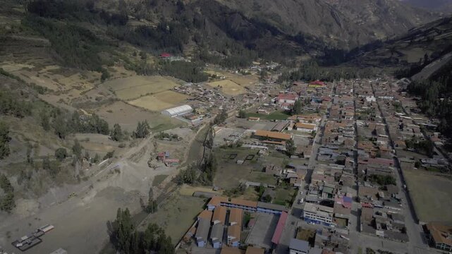 Aerial view of the historic town of Chavin de Huantar nestled in a valley surrounded by the Andes mountains in Chavin de Huantar, Ancash, Peru.