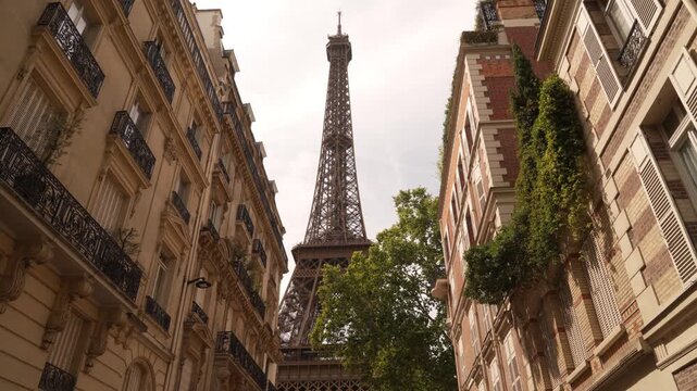 Eiffel Tower down a corridor of Paris apartment buildings