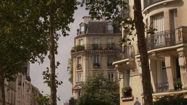 Eiffel Tower above balconies of a curved Paris apartment block