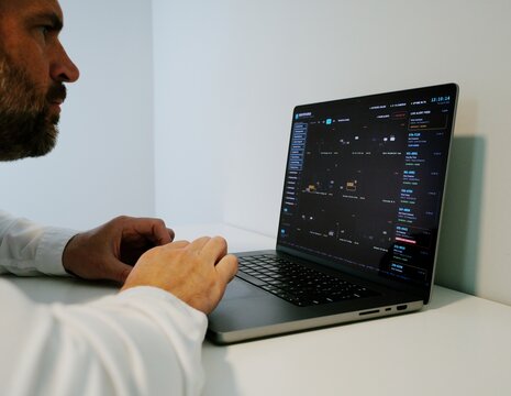 Investigator Detective on laptop using automated license plate reader software to track vehicle locations, illustrating law enforcement surveillance