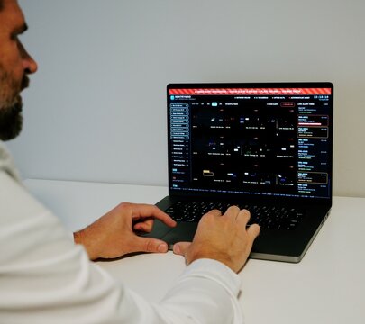 Investigator Detective on laptop using automated license plate reader software to track vehicle locations, illustrating law enforcement surveillance