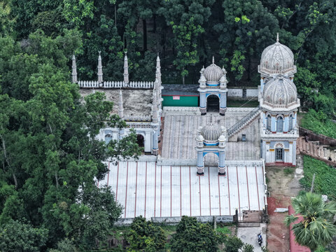 Dhanbari, Dhaka Division, Bangladesh - 08 July 2026: Aerial view of the historic Dhanbari Nawab Bari Mosque with ornate domes, minarets, and a tiled courtyard amidst trees.