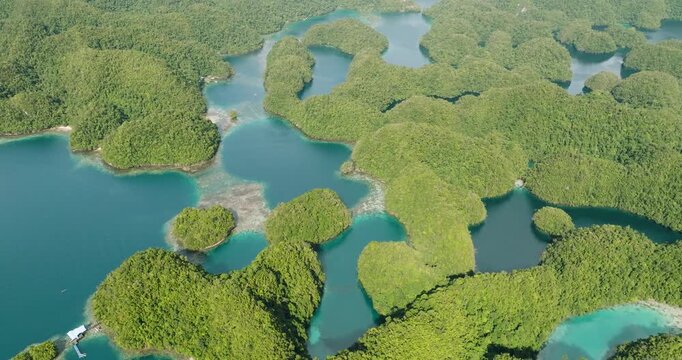Aerial view of Bucas Grande islands featuring lush green vegetation, turquoise lagoons, and clear water in Siargao, Caraga, Philippines.