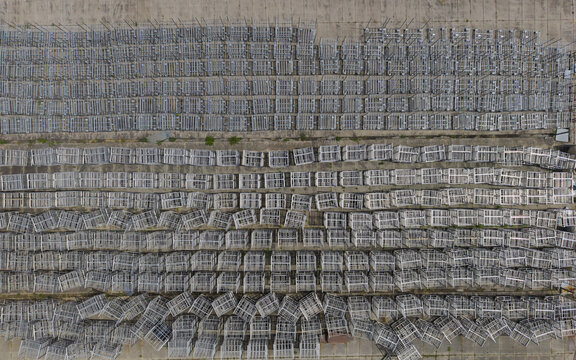 Aerial view of metal storage crates arranged in neat rows on a concrete surface at Oud-Wulven in Houten, Utrecht, Netherlands.
