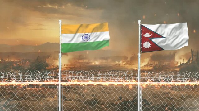 India and Nepal national flags waving in front of burning war zone background with barbed wire fence.