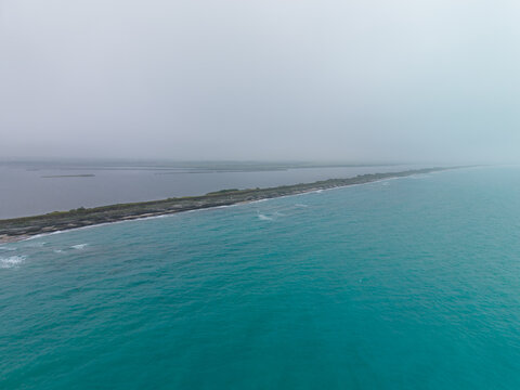 Aerial view of the Pomorie sandbar separating the Black Sea from the Pomorie Lake under a cloudy sky in Pomorie, Burgas, Bulgaria.