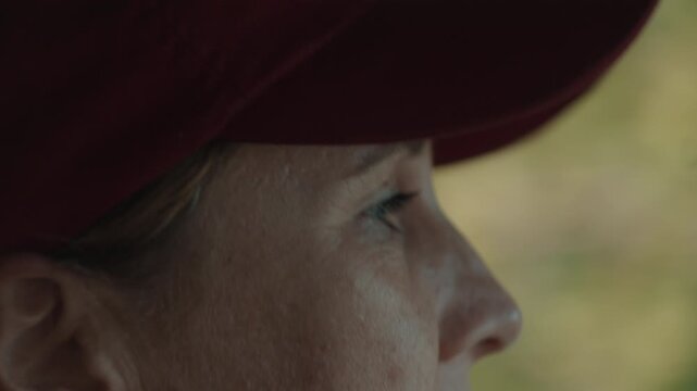 Close up portrait of the young woman in red shirt steers 4x4 off road car in the wild on sunset