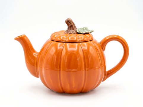 Ceramic pumpkin shaped teapot isolated on white background