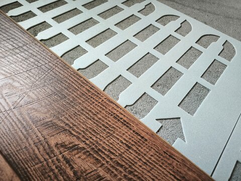 Laminate and sheet underlay for underfloor heating systems