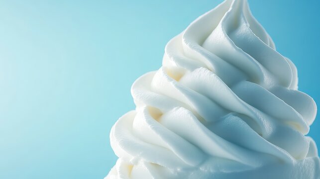Close-up of soft-serve ice cream swirl with intricate texture and a bright, cool, light blue background