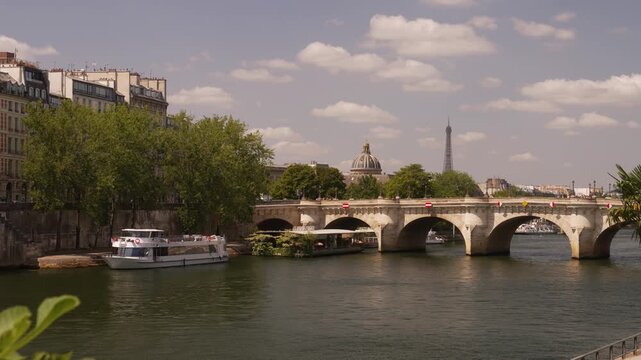 Stone bridge over the Seine and a distant Paris skyline tower
