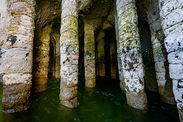 Naklejka premium Natural stone pillars standing in water inside Crowley Lake Stone Columns in California
